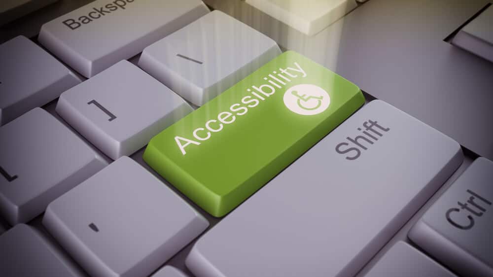 Altered image of a keyboard with an "accessibility" button added and glowing.