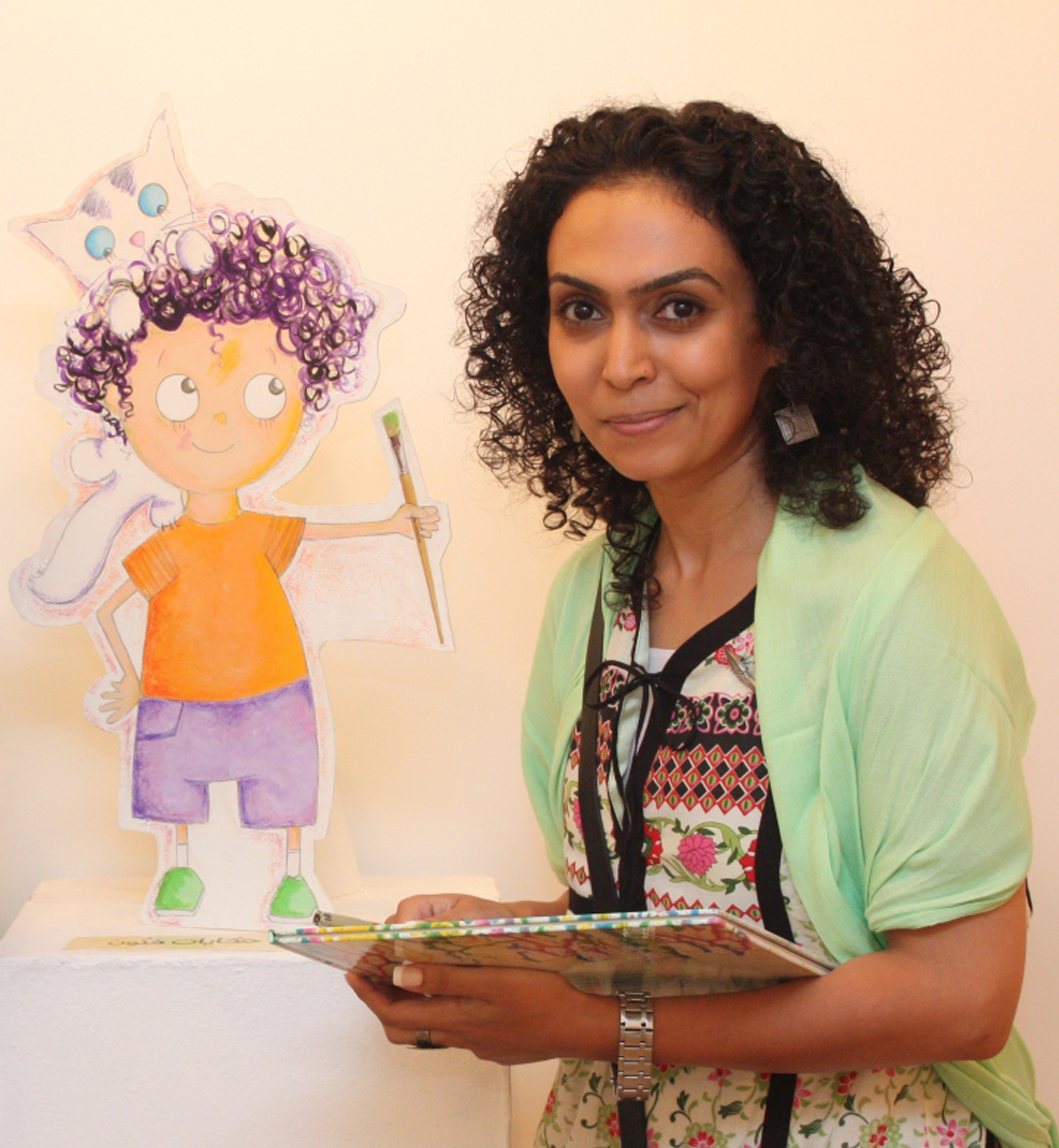 Image of woman in front of illustration of boy. Woman is reading a book.