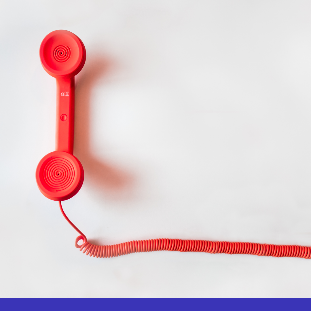 Image of a red telephone on a white background with purple trim the bottom of the image.